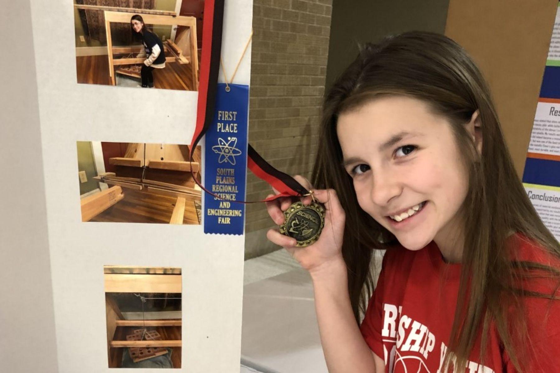 Westwind Student holding medal at Regional Science Fair